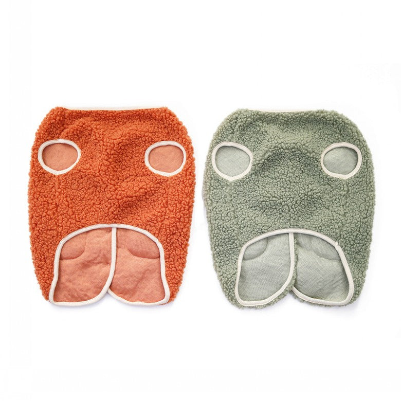 Orange and green sherpa dog vests laid flat, underside view showing the leg openings