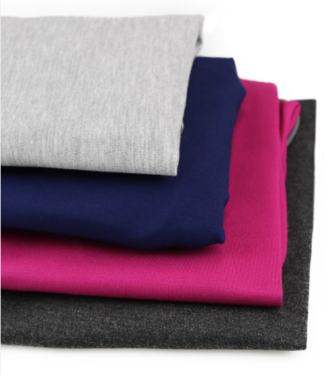 Snug wrap jacket for dogs fabric in Light Gray, Blue, Rose Red and Dark Gray, folded in a stack