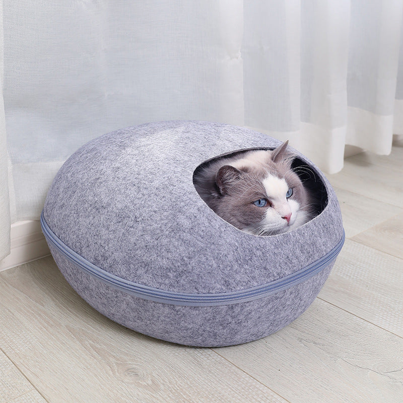 Light gray felt cat cave bed with a round opening and a soft cushion inside