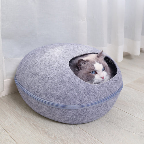 Light gray felt cat cave bed with a round opening and a soft cushion inside