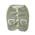 Green sherpa dog vest laid flat, with buttons and two pockets