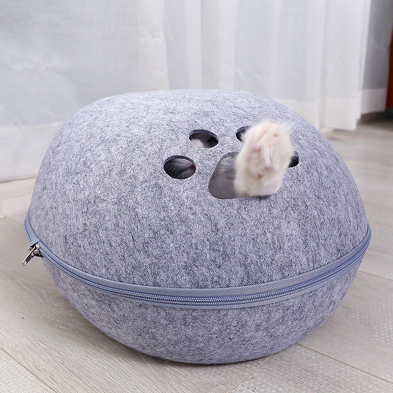 Felt cat cave bed in Light Gray, back view with paw-print holes and a cat's paw poking through
