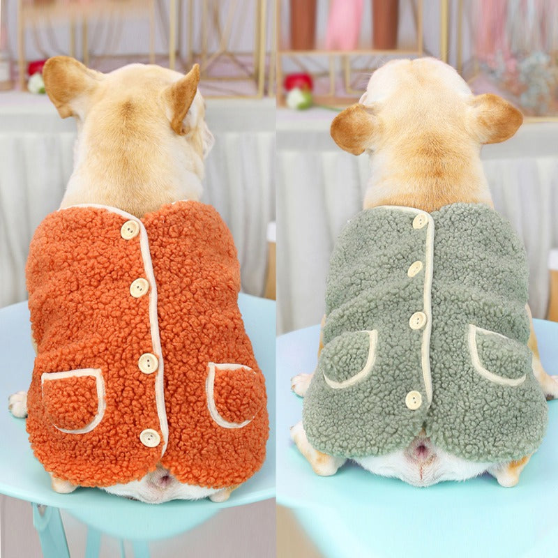 Two French bulldogs from behind wearing the orange and the green sherpa dog vest